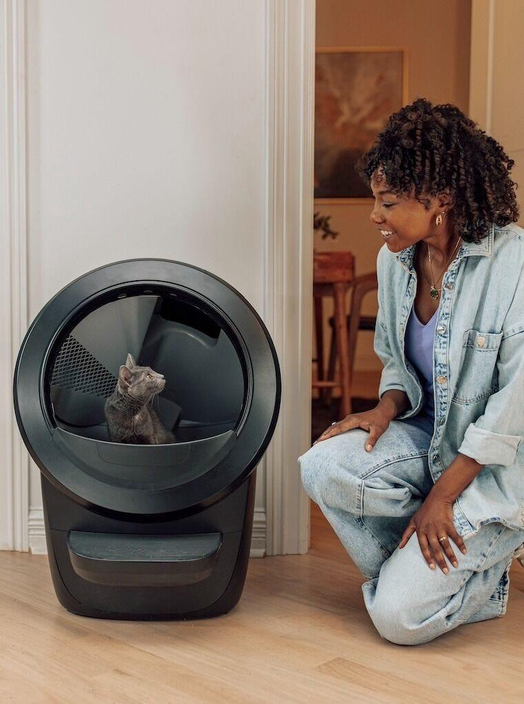 Litter-Robot 4 automatic self-cleaning litter box in black with cat inside