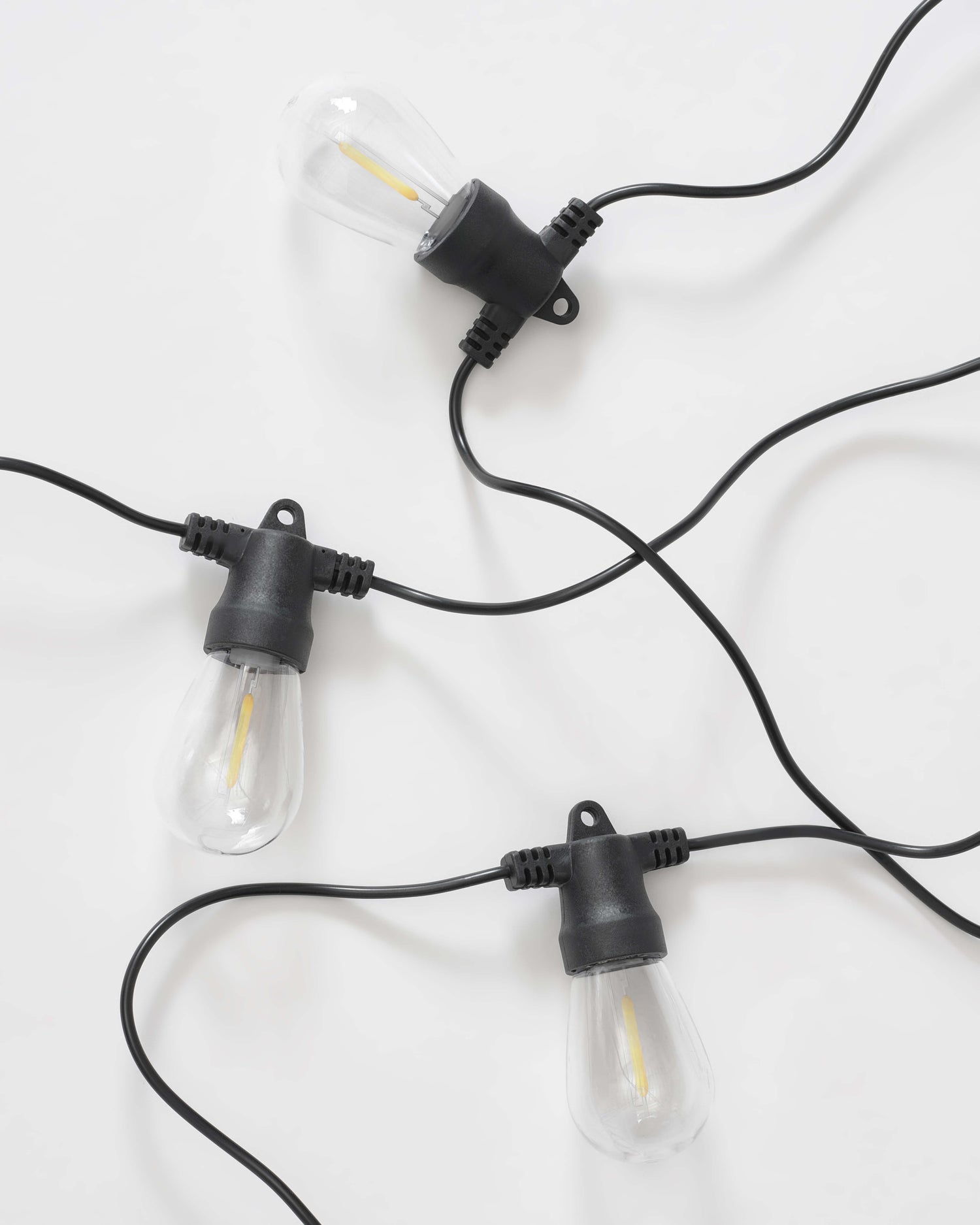 Brightech Ambience Pro solar-powered outdoor string lights with Edison-style bulbs on a patio