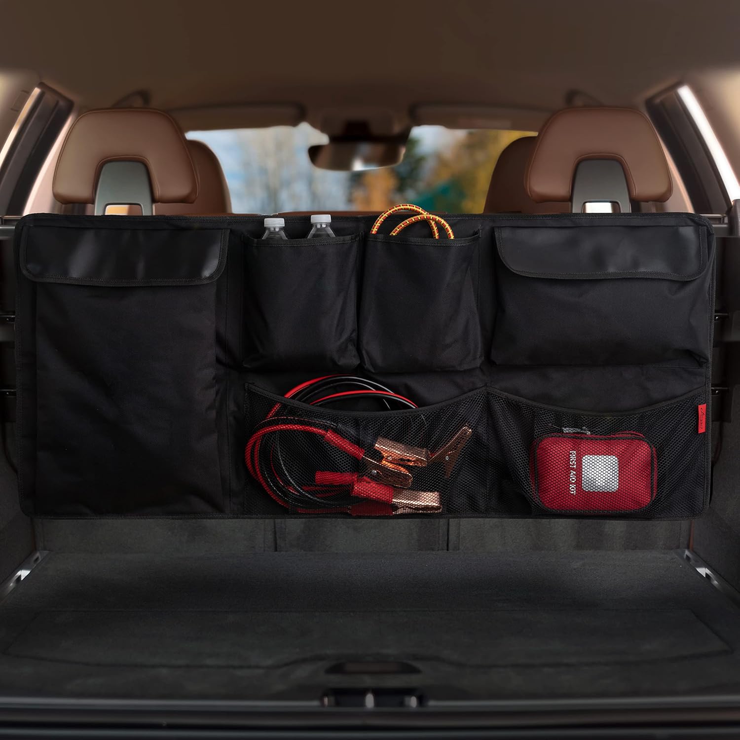 Lusso Gear Hanging Trunk Organizer XL mounted on car headrest with pockets holding accessories