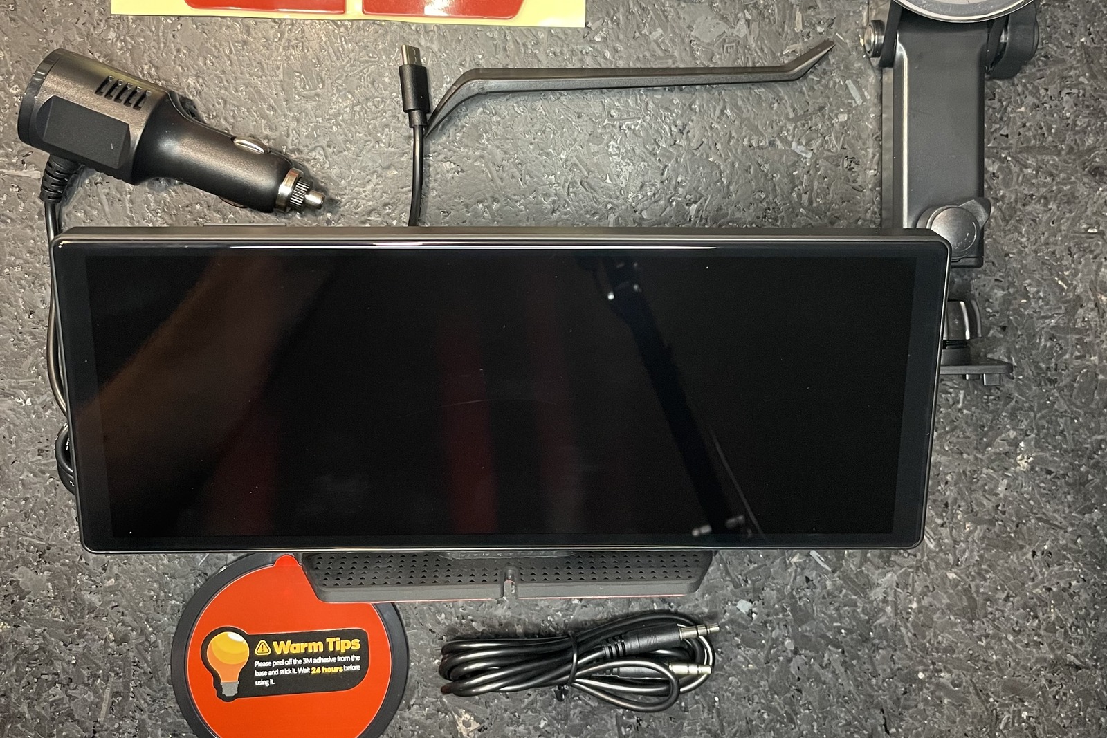 LAMTTO RC16 screen, car charger, AUX cable, and mounting hardware laid out, with no camera included